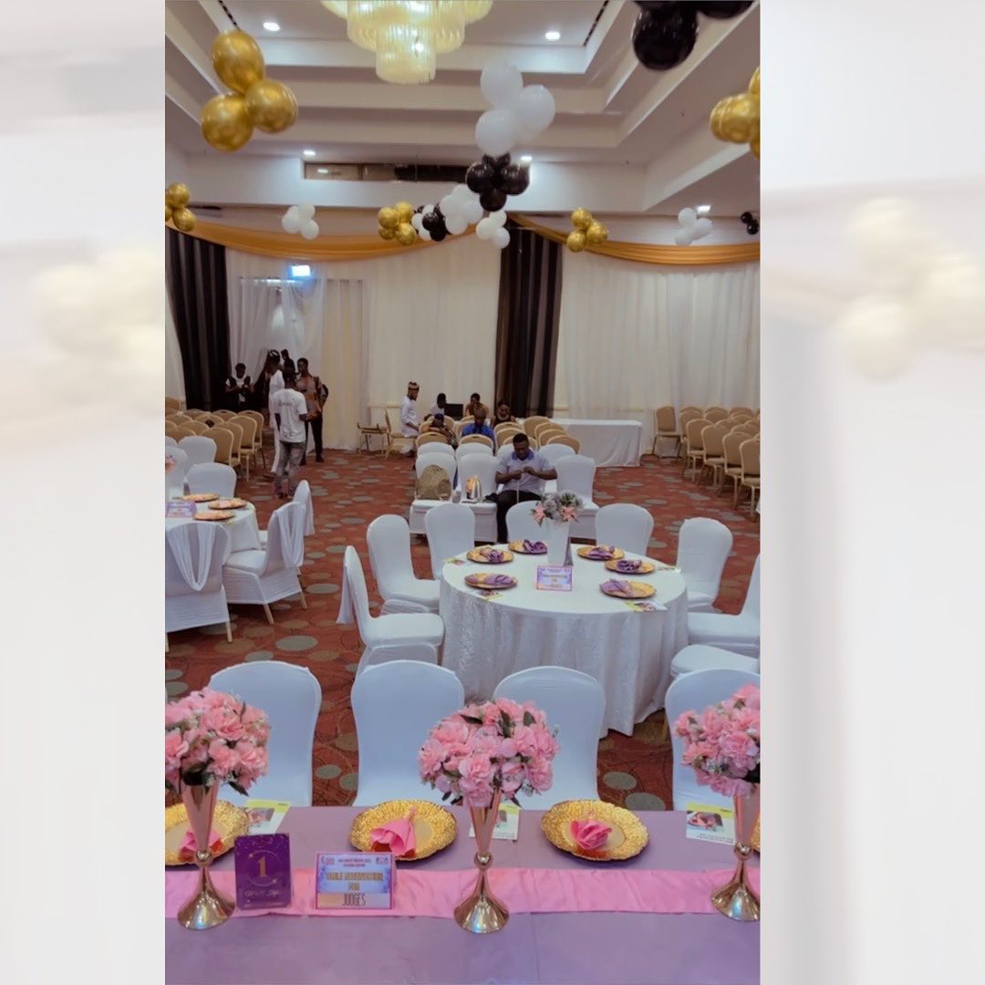 Golden Opulence Wedding — grand hall with pink florals and gold balloons by M&M Styles Abuja
